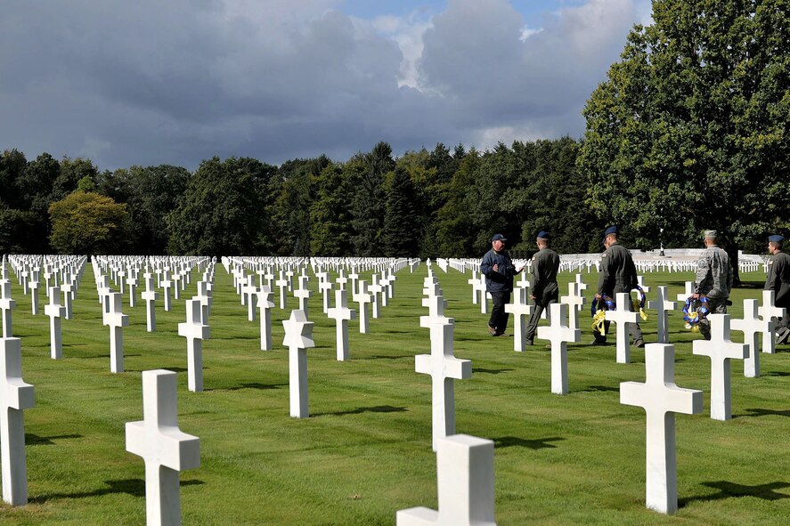 U.S Air Force members form Little Rock Air Force Base, Ark., get to know the history of the grounds at Ardennes American Military Cemetery in Neupre, Belgium, before a wreath laying ceremony Sept. 12, 2017. The ceremony honored several squadrons from WWII that have roots back to current units at Little Rock AFB. (U.S. Air Force photo by Airman 1st Class Codie Collins)