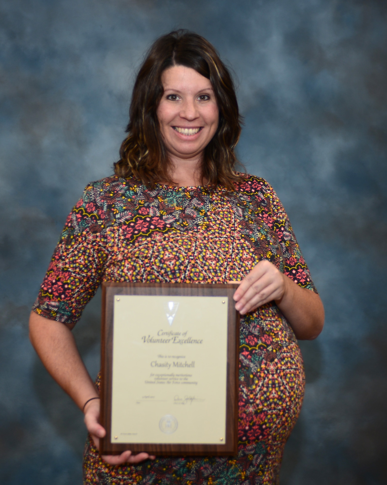 Chasity Mitchell, the family matters coordinated with the Air Force Sergeants Association, holds the Volunteer Excellence Award at Ellsworth Air Force Base, S.D., Sept. 19, 2017. The Volunteer Excellence Award recognizes federal civilians, family members, military retirees, and federal retirees with exceptional long term community support – not just a single act or achievement.