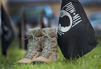 For a moment and hours prior to the National Prisoner of War and Missing in Action Recognition Day ceremony, a pair of boots sit beside a POW/MIA flag Sept. 15, 2017, on Dover Air Force Base, Del. A formation of 20 flags symbolized a flight made up of POW/MIA personnel and was placed between two Team Dover 20-man flights. (U.S. Air Force photo by Roland Balik)
