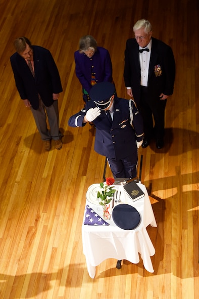 Rufus Ward Jr., Jo Shumake and retired Lt. Col. Gene Smith stand with Airman 1st Class Andrew Inocencio, Columbus Air Force Base Honor Guardsman, as they perform a Prisoner of War and Missing In Action remembrance ceremony Sept. 15, 2017, during the 14th Flying Training Wing’s 70th Air Force Birthday Ball at the Trotter Convention Center in Columbus, Mississippi. Ward’s and Shumake’s fathers were POWs during World War II, and Smith was a POW in Vietnam for more than five years. (U.S. Air Force photo by Melissa Doublin)
