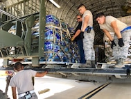 Airman from the 502nd Logistics Readiness Squadron load relief supplies aboard a C-17 Galaxy Sept. 22, 2017 at Joint Base San Antonio-Kelly Field.  The C-17, from the 21st Airlift Squadron at Travis Air Force Base, Calif., was bound for St. Croix, U.S.  Virgin Islands, to aid in Hurricane Maria relief efforts.  (U.S. Air Force image/Dan Hawkins)