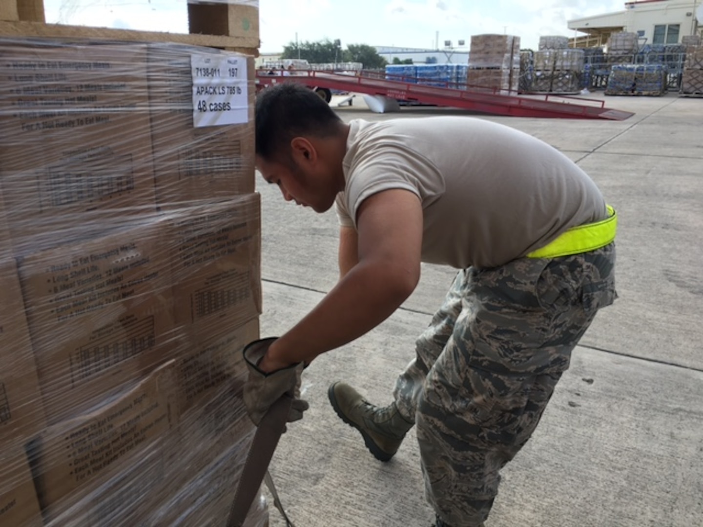Airman 1st Class Mavin Raboy, 26th Aerial Port Squadron straps down cargo pallets Sept. 22, 2017 at Joint Base San Antonio-Kelly Field.  The supplies were being staged at the Federal Emergency Management Agency’s Incident Support Base at Kelly for transport to areas devastated by Hurricane Maria (U.S. Air Force image/Dan Hawkins)