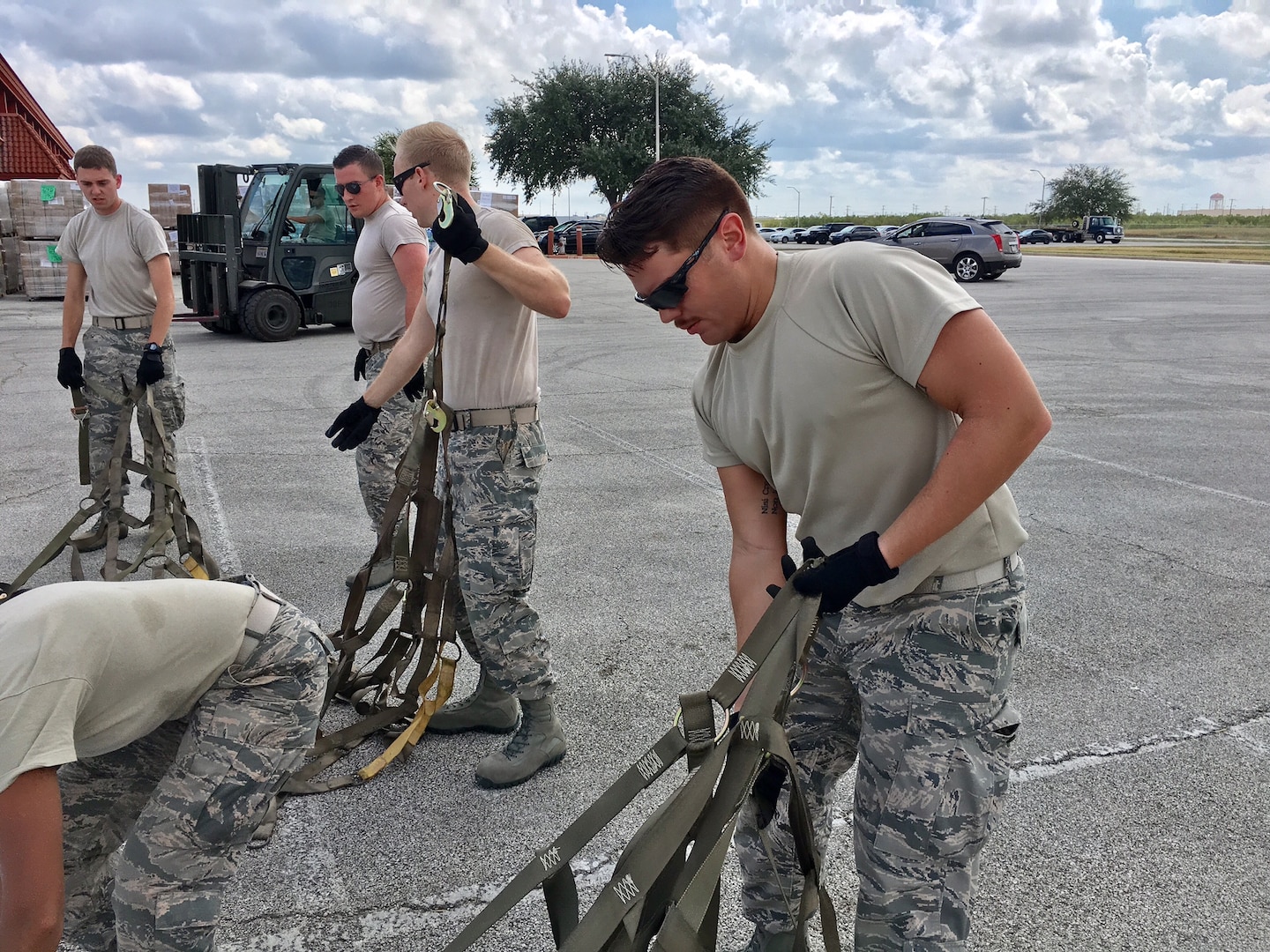 Second Lt. Alberto, 12th Training Squadron student, straightens out cargo straps to help prepare Hurricane Maria relief supplies for air transport Sept. 22, 2017, at Joint Base San Antonio-Kelly Field.  The supplies were being staged at the Federal Emergency Management Agency’s Incident Support Base at Kelly for transport to areas devastated by Hurricane Maria. (U.S. Air Force image/Dan Hawkins)