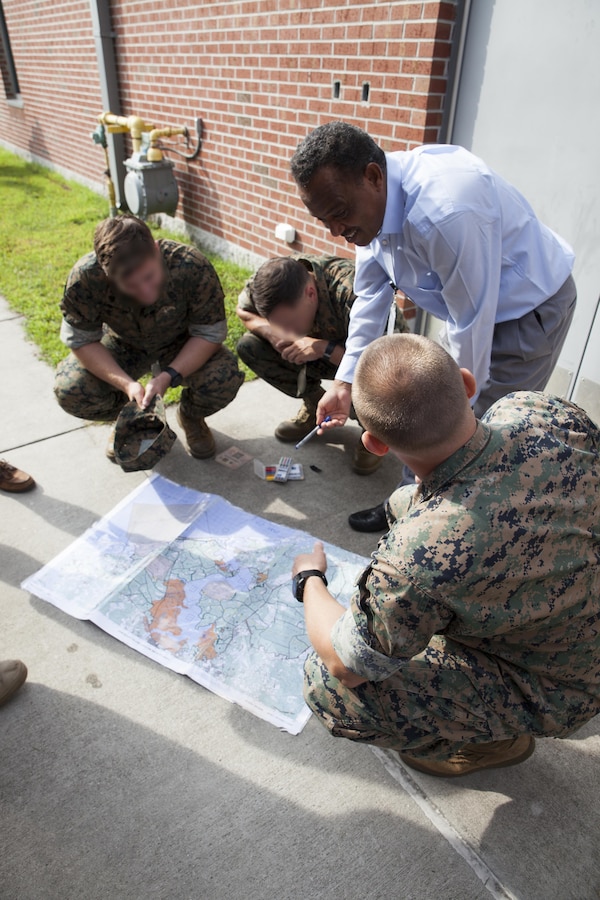 Critical skills operators with U.S. Marine Corps Forces, Special Operations Command, use their target language to explain land navigation to their instructors during the Foreign Internal Defense event at the Marine Raider Training Center on Stone Bay, Marine Corps Base Camp Lejeune, N.C., Sept. 7, 2017.  The FID event allows CSOs to use their newly acquired language skills in a controlled environment, and practice mission-required objectives before being sent down range. (U.S. Marine Corps photo by Cpl. Bryann K. Whitley)