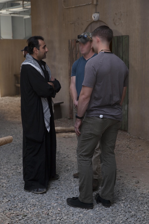 Critical skills operators with U.S. Marine Corps Forces, Special Operations Command, use their target language to build rapport with town's people during a week-long, simulated deployed role play event at the Infantry Immersion Trainer on Marine Corps Base Camp Lejeune, N.C., Sept. 19, 2017.  The event is a constantly moving cultural specific environment where students are engaged by role players over various scenarios.  (U.S. Marine Corps photo by Cpl. Bryann K. Whitley)