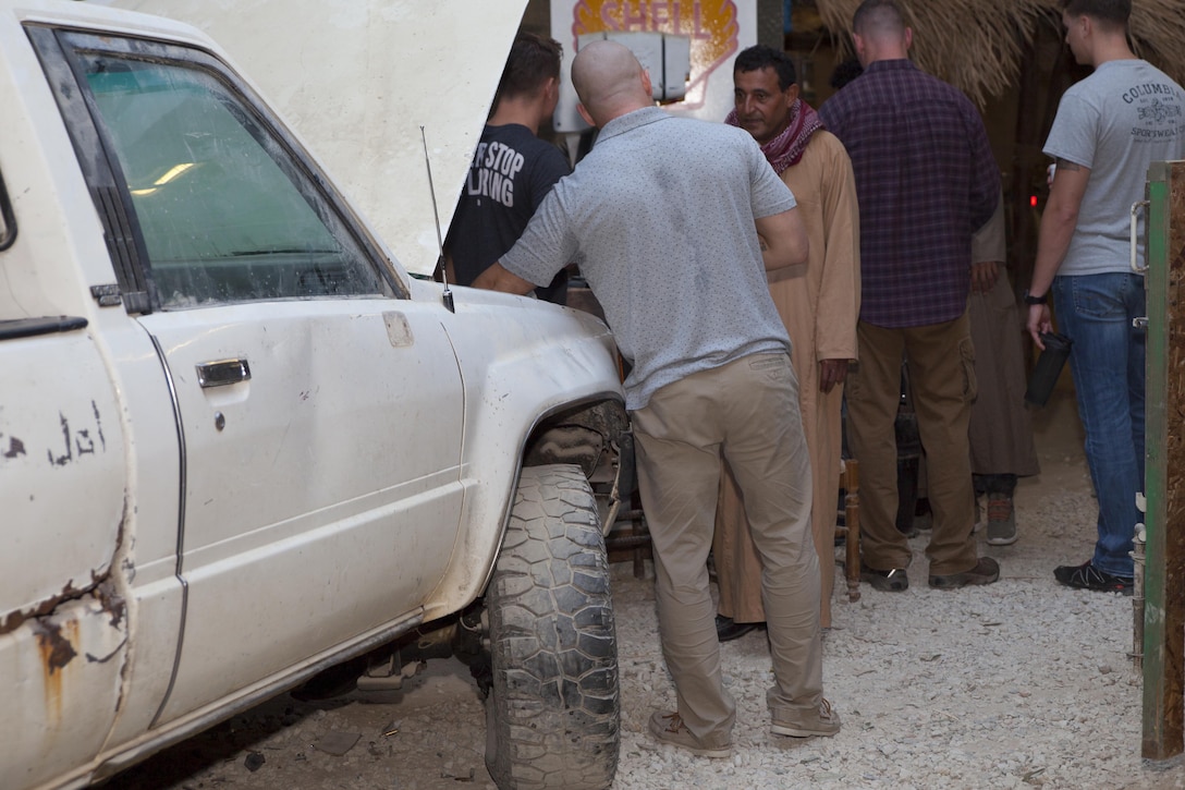 Critical skills operators with U.S. Marine Corps Forces, Special Operations Command, use their target language to build rapport with town's people during a week-long, simulated deployed role play event at the Infantry Immersion Trainer on Marine Corps Base Camp Lejeune, N.C., Sept. 19, 2017.  The event is a constantly moving cultural specific environment where students are engaged by role players over various scenarios.  (U.S. Marine Corps photo by Cpl. Bryann K. Whitley)