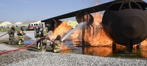 Members of the Tulsa Fire Department (wearing tan bunker gear) work with a member of the 72nd Civil Engineer Squadron, fire department, during a training event using a full-size aircraft fire training device Sept. 13, 2017, Tinker Air Force Base, Oklahoma. The Tulsa firefighters were guests of the 72nd Civil Engineer Squadron, fire department, who underwent recertification training.