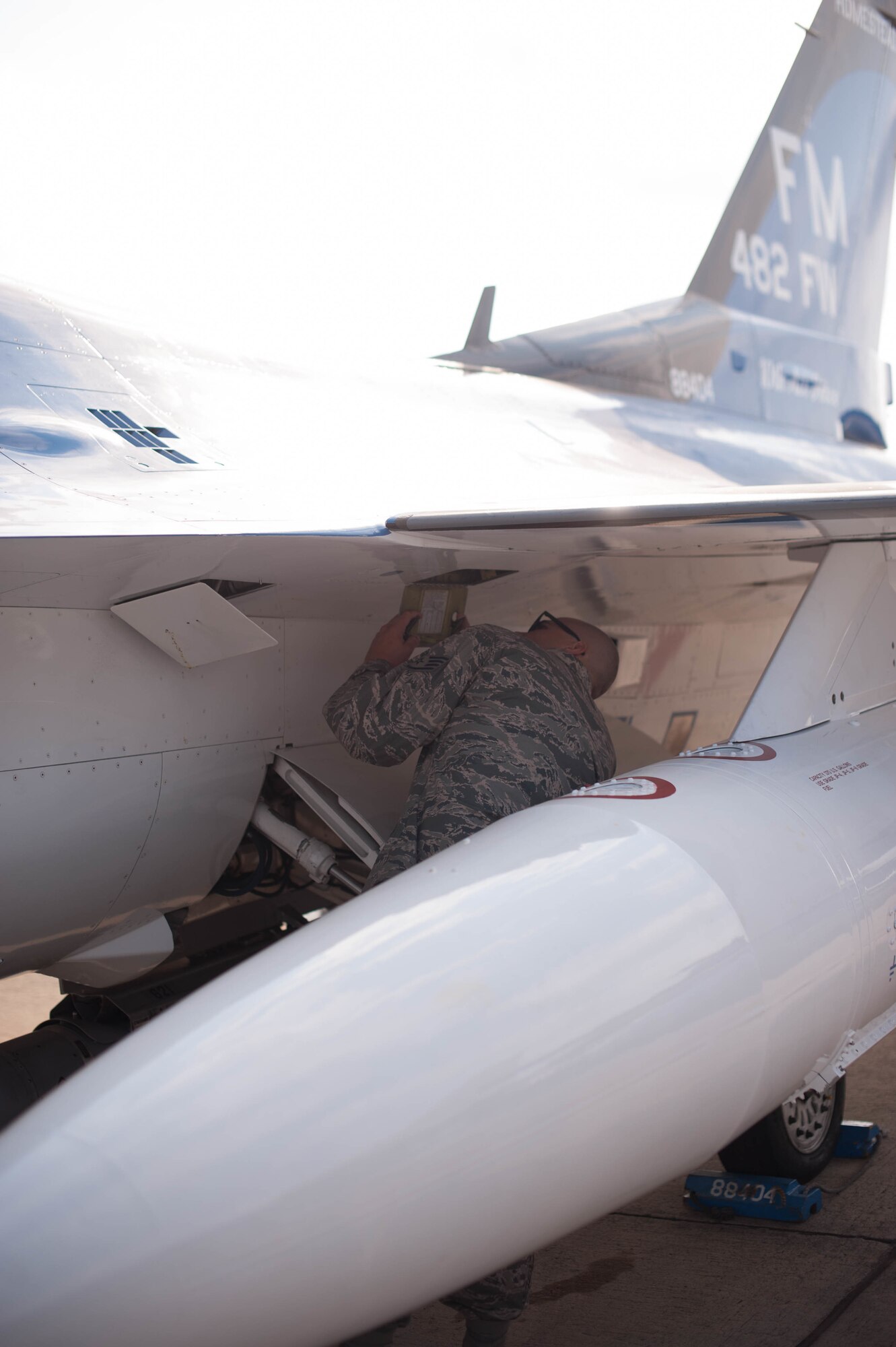 Staff Sgt. Joel Folguiera performs inspections on an F-16 after it relocated to Naval Air Station Fort Worth Joint Reserve Base, Texas, in order to stay out of harm's way during Hurricane Irma.