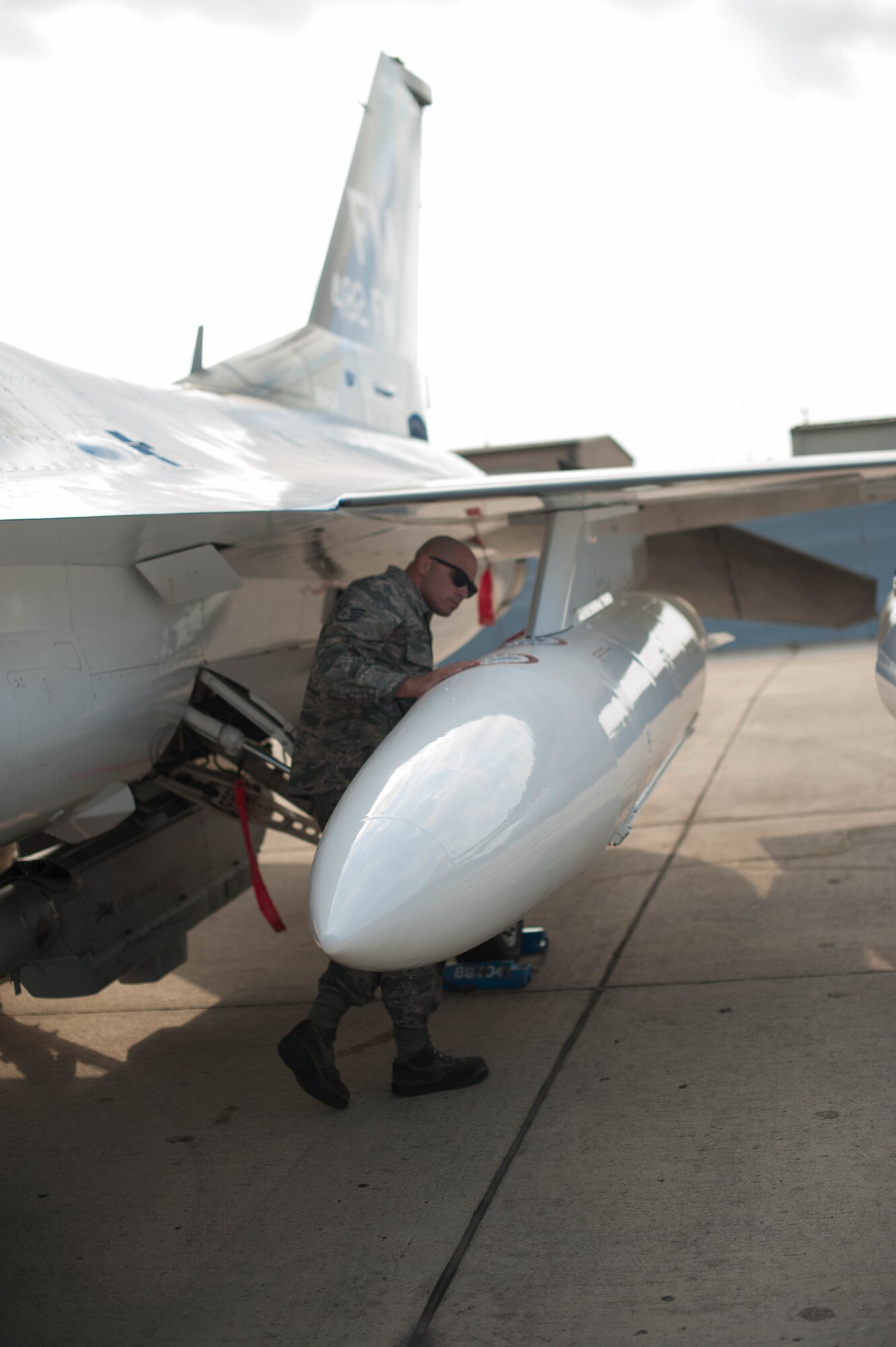 Staff Sgt. Joel Folguiera performs inspections on an F-16 after it relocated to Naval Air Station Fort Worth Joint Reserve Base, Texas, in order to stay out of harm's way during Hurricane Irma.