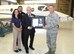 Brig. Gen. Steven J. Bleymaier, former commander, Ogden Air Logistics Complex, Hill Air Force Base, Utah, presents AMARG’s deputy director, Timothy S. Gray, the T-1A Military Repair Station certification letter from the Air Force Sustainment Center, Flight Standards Management Office.