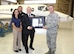 Brig. Gen. Steven J. Bleymaier, former commander, Ogden Air Logistics Complex, Hill Air Force Base, Utah, presents AMARG’s deputy director, Timothy S. Gray, the T-1A Military Repair Station certification letter from the Air Force Sustainment Center, Flight Standards Management Office.