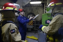 LT O’brien instructs SA Baker-Rodriguez and BM3 Shoopman on proper firefighting techniques during emergency response drills.
