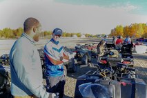 U.S. Air Force Airman 1st Class Isaac Johnson, a 354th Fighter Wing photojournalist, speaks to an all-terrain vehicle (ATV) safety course instructor during training Sept. 14, 2017, at Eielson Air Force Base, Alaska. After the class, seven Airmen stationed at Eielson received their certification to train ATV safety. (U.S. Air Force photo by Airman 1st Class Eric M. Fisher)