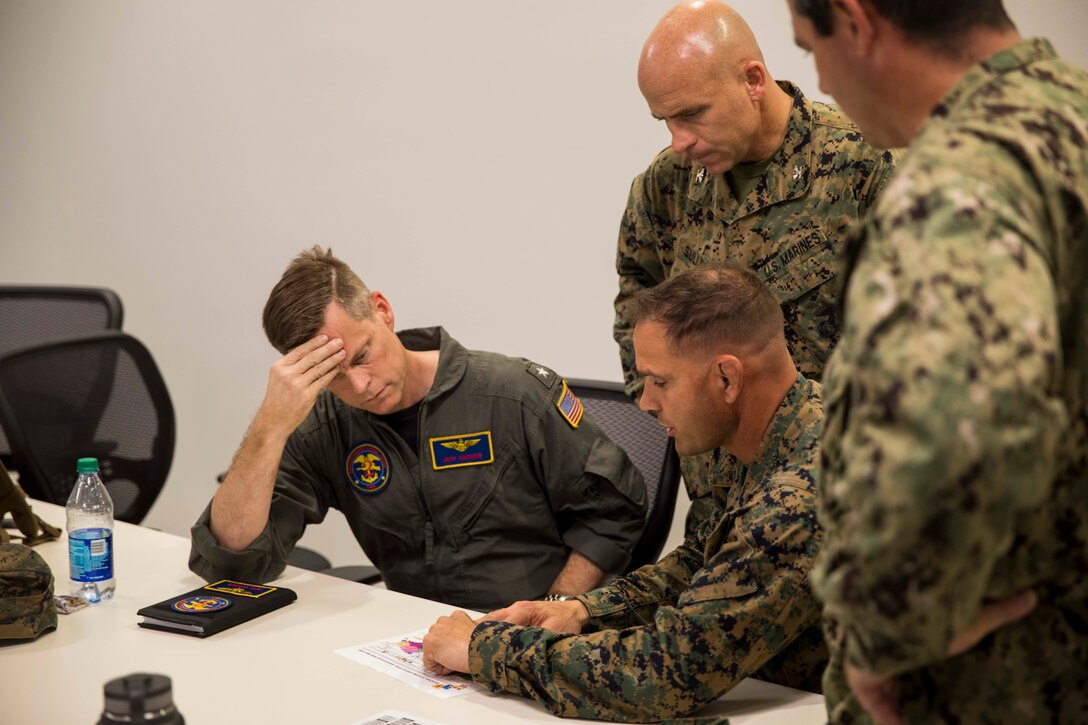 U.S. Navy Rear Adm. Jeff Hughes (left), Commander, Expeditionary Strike Group 2, embarked aboard the amphibious assault ship USS Kearsarge (LHD 3) discusses operations with senior leadership from the 26th Marine Expeditionary Unit (MEU) at Guaynabo, Puerto Rico, Sept. 22, 2017. Kearsarge and the 26th MEU are assisting with relief efforts in the aftermath of Hurricane Maria at Guaynabo, Puerto Rico, Sept. 22, 2017. The Department of Defense is supporting the Federal Emergency Management Agency, the lead federal agency, in helping those affected by Hurricane Maria to minimize suffering and is one component of the overall whole-of-government response effort. (U.S. Navy Photo by Mass Communication Specialist 3rd Class Jacob Goff)