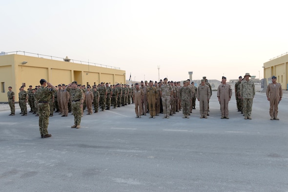 United Kingdom Air Component Commander and Air Officer Commanding 83 Expeditionary Air Group, Air Commodore Johnny Stringer, facing the camera, returns a solute from the Commanding Officer of 901 Expeditionary Air Wing as UK members, formation on the left, and various leaders from the coalition forces stand at attention at Al Udeid Air Base, Qatar, Sept. 16, 2017.