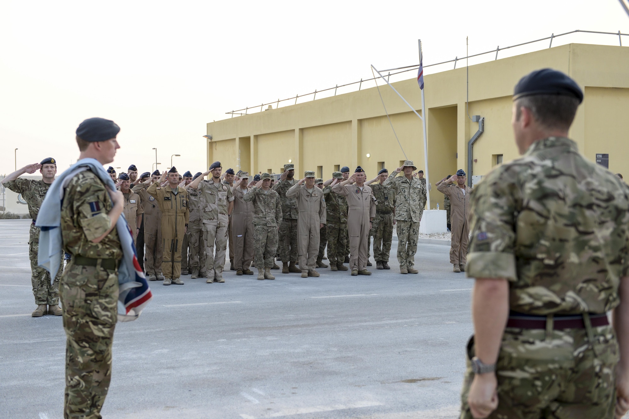 United Kingdom Air Component Commander and Air Officer Commanding 83 Expeditionary Air Group, Air Commodore Johnny Stringer, right center, addresses UK forces along with various leaders from the coalition forces following the Battle of Britain commemoration ceremony at Al Udeid Air Base, Qatar, Sept. 16, 2017.