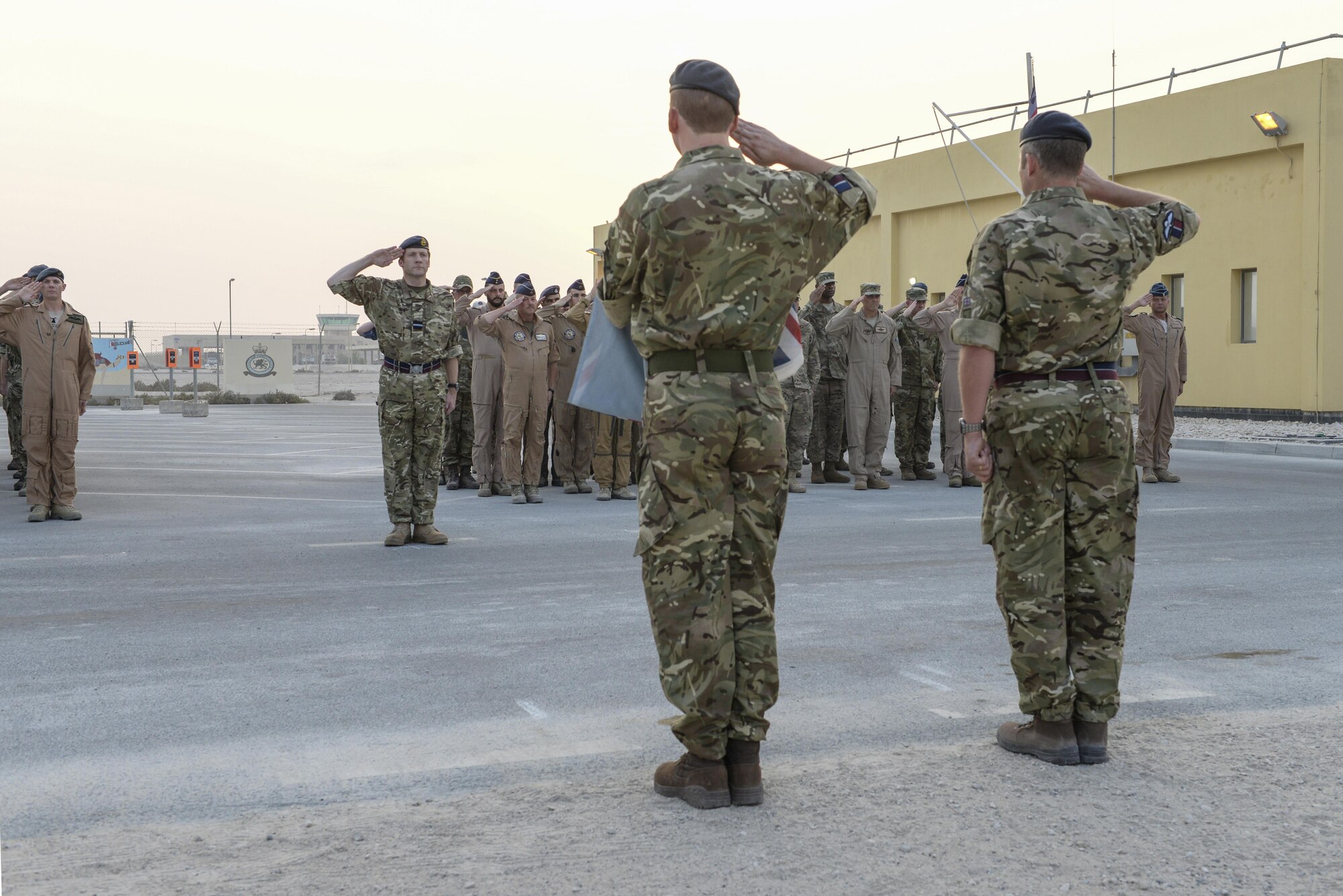 United Kingdom Air Component Commander and Air Officer Commanding 83 Expeditionary Air Group, Air Commodore Johnny Stringer, right center, addresses UK forces along with various leaders from the coalition forces following the Battle of Britain commemoration ceremony at Al Udeid Air Base, Qatar, Sept. 16, 2017.