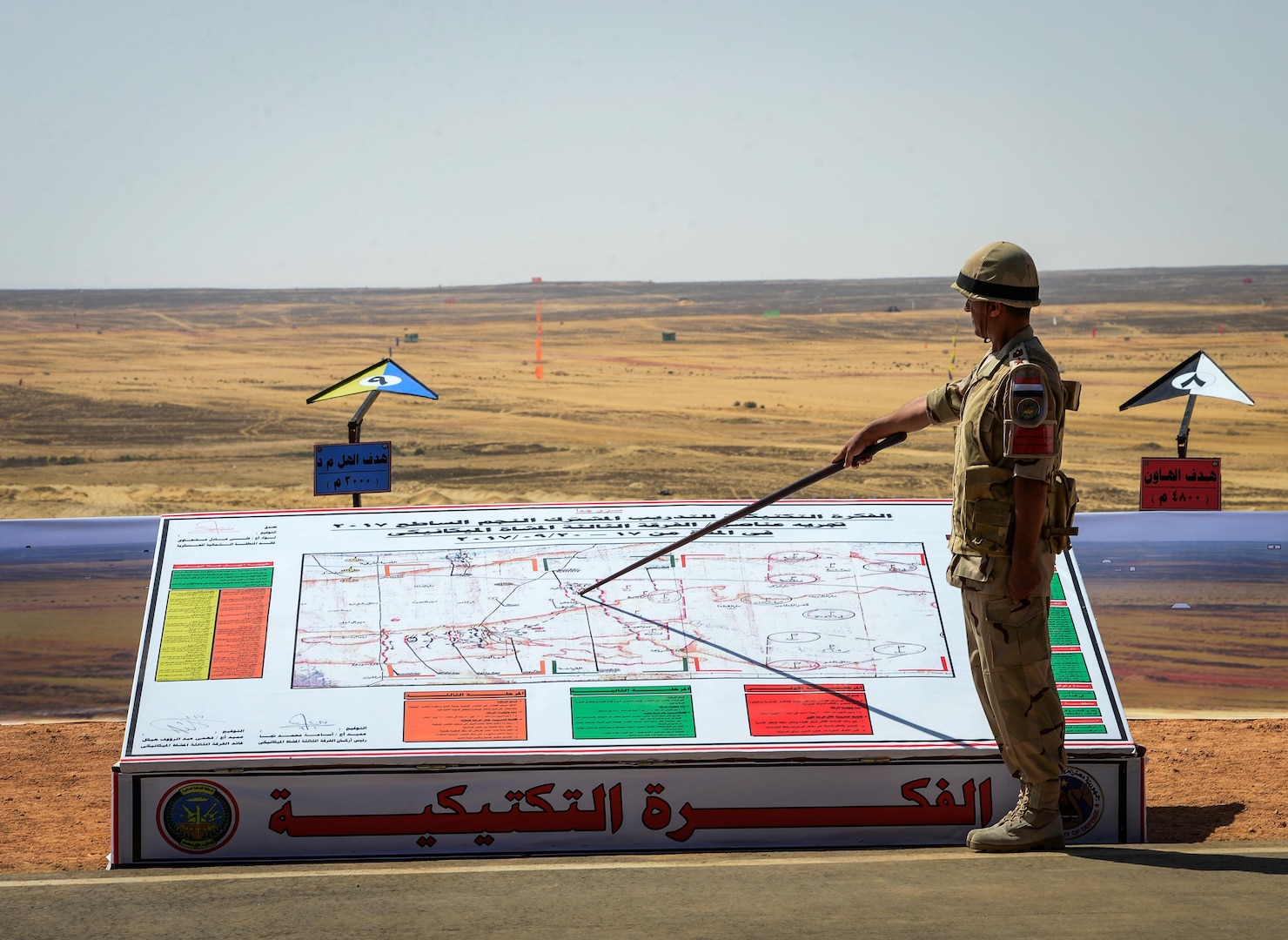 An Egyptian soldier points out exercise maneuvers before a combined arms live fire exercise during Bright Star 2017, Sept. 20, 2017, at Mohamed Naguib Military Base, Egypt. The bilateral exercise, Bright Star, targets strengthening military-to-military relationships between U.S. forces and its Egyptian partners in the CENTCOM area of responsibility. (U.S. Air Force photo by Staff Sgt. Michael Battles)