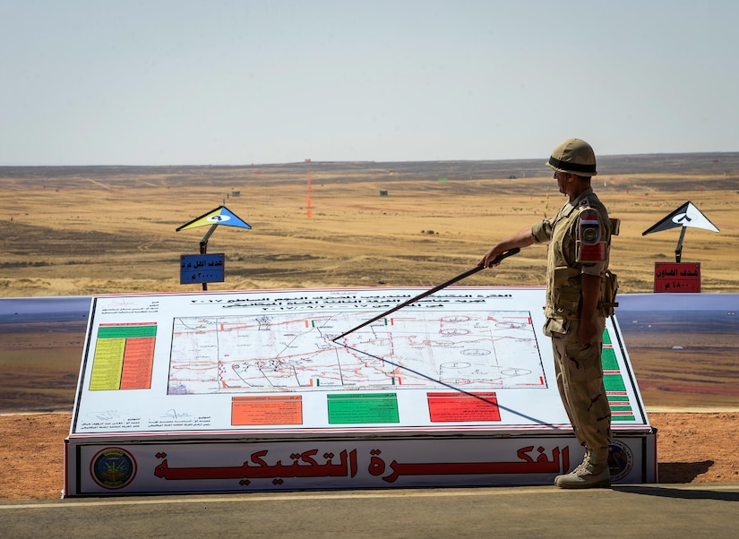 An Egyptian soldier points out exercise maneuvers before a combined arms live fire exercise during Bright Star 2017, Sept. 20, 2017, at Mohamed Naguib Military Base, Egypt. The bilateral exercise, Bright Star, targets strengthening military-to-military relationships between U.S. forces and its Egyptian partners in the CENTCOM area of responsibility. (U.S. Air Force photo by Staff Sgt. Michael Battles)