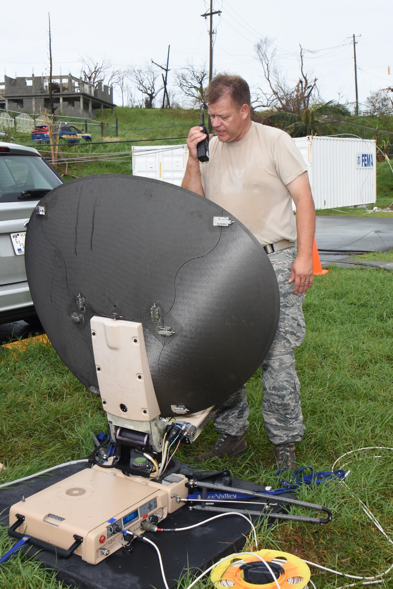 Air National Guard Chief Master Sgt. Don Johnnson, Joint Incident Site Communication Capability noncommissioned officer in charge with the 151st Air Refueling Wing Communications Flight in Salt Lake City, Utah, confirms configuration status of a SWE-DISH CCT120 satellite dish outside the Leonard B. Francis Armory in St. Thomas, U.S. Virgin Islands, Sept. 20, 2017. The Sept. 7 deployment of the Utah JISCC helped re-establish critical military and emergency civil service communications within areas of the U.S. Virgin Islands severely impacted by Hurricanes Irma and Maria. (U.S. Air National Guard photo by Master Sgt. Paul Gorman)