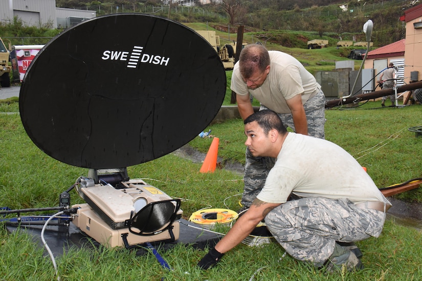 Chief Master Sgt. Don Johnnson and Staff Sgt. Tony Baca, Joint Incident Site Communication Capability team members with the 151st Air Refueling Wing Communications Flight in Salt Lake City, Utah, set up a SWE-DISH CCT120 satellite dish outside the Leonard B. Francis Armory in St. Thomas, U.S. Virgin Islands, Sept. 20, 2017. The Sept. 7 deployment of the Utah JISCC helped re-establish critical military and emergency civil service communications within areas of the U.S. Virgin Islands severely impacted by Hurricanes Irma and Maria. (U.S. Air National Guard photo by Master Sgt. Paul Gorman)