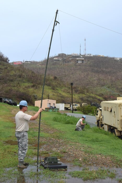 Master Sgt. David Fernelius, left, and Airman 1st Class David Zham, Joint Incident Site Communication Capability team members with the 151st Air Refueling Wing Communications Flight in Salt Lake City, Utah, erect an NVIS high frequency antenna outside the Leonard B. Francis Armory in St. Thomas, U.S. Virgin Islands, Sept. 20, 2017. The Sept. 7 deployment of the Utah JISCC helped re-establish critical military and emergency civil service communications within areas of the U.S. Virgin Islands severely impacted by Hurricanes Irma and Maria. (U.S. Air National Guard photo by Master Sgt. Paul Gorman)