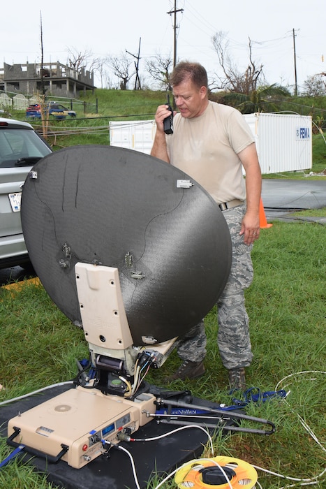 Air National Guard Chief Master Sgt. Don Johnnson, Joint Incident Site Communication Capability noncommissioned officer in charge with the 151st Air Refueling Wing Communications Flight in Salt Lake City, Utah, confirms configuration status of a SWE-DISH CCT120 satellite dish outside the Leonard B. Francis Armory in St. Thomas, U.S. Virgin Islands, Sept. 20, 2017. The Sept. 7 deployment of the Utah JISCC helped re-establish critical military and emergency civil service communications within areas of the U.S. Virgin Islands severely impacted by Hurricanes Irma and Maria. (U.S. Air National Guard photo by Master Sgt. Paul Gorman)