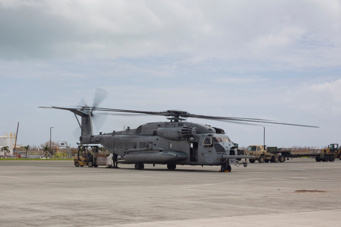 Department of Defense personnel offloads essential relief supplies from a U.S. Marine Corps CH-53E Super Stalion helicopter with Marine Medium Tiltrotor Squadron (VMM) 162 (Reinforced), 26th Marine Expeditionary Unit (MEU), in St. Thomas, U.S. Virgin Islands, Sept. 23, 2017. The 26th MEU  is assisting with relief efforts in the aftermath of Hurricane Maria. The Department of Defense is supporting the Federal Emergency Management Agency, the lead federal agency in helping those affected by Hurricane Maria to minimize suffering and is one component of the overall whole-of-government response effort. (U.S. Navy photo by Mass Communication Specialist 3rd Class Dana D. Legg)