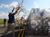 Department of Health and Human Services logistician throws a cargo net over a pallet on the flightline at Dobbins Air Reserve Base, Ga. Sept. 21, 2017. This cargo included items needed to build a hospital from scratch – everything from the tents required to house the temporary structure to the medical equipment used to treat patients. (U.S. Air Force photo/Don Peek)