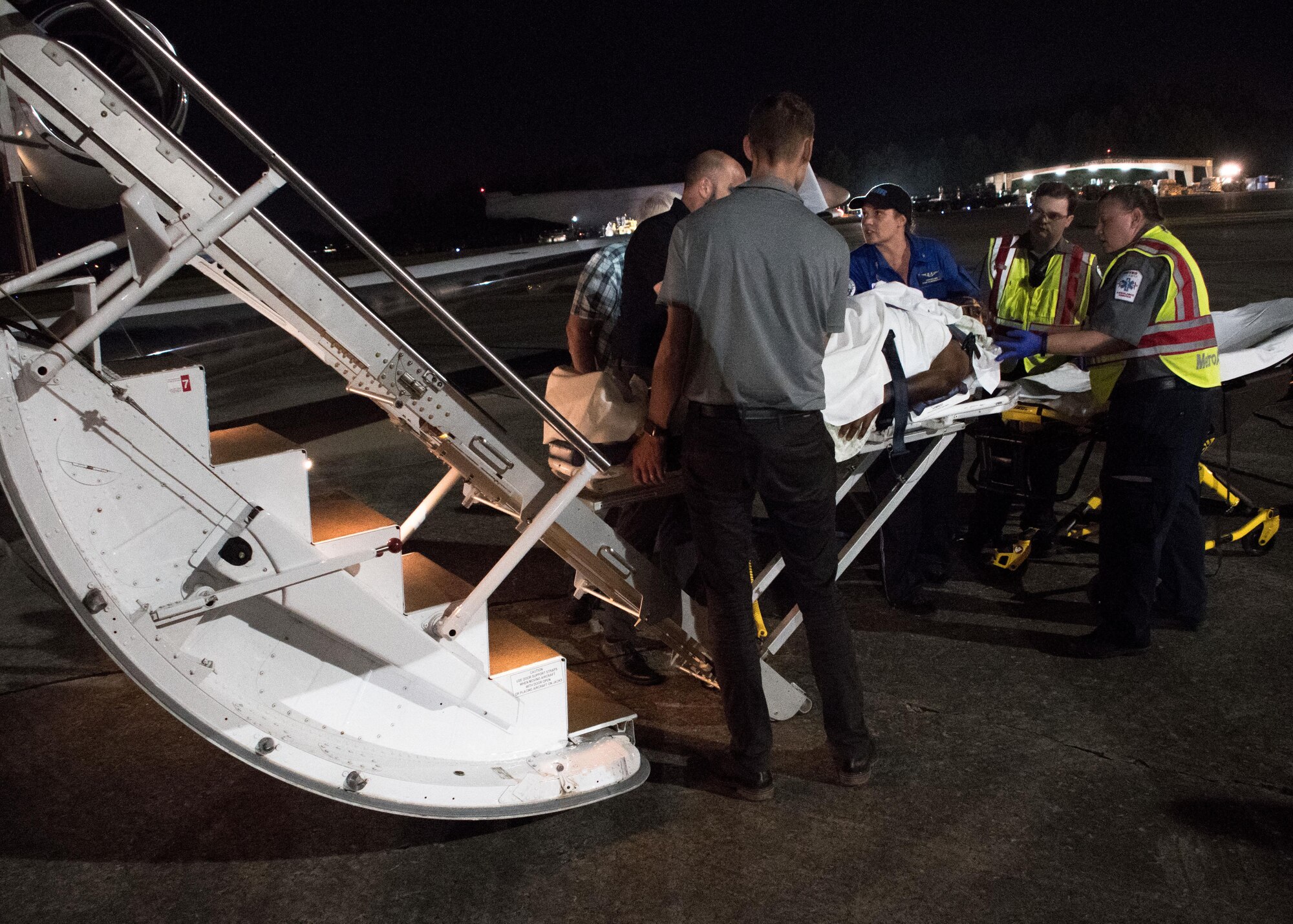 Medical personnel transfer a patient from a plane to stretcher on the flightline at Dobbins Air Reserve Base, Ga. Sept. 21, 2017. Dobbins received patients from the U.S. Virgin Islands who were then processed and transported to metro Atlanta medical facilities. (U.S. Air Force photo/Staff Sgt. Andrew Park)