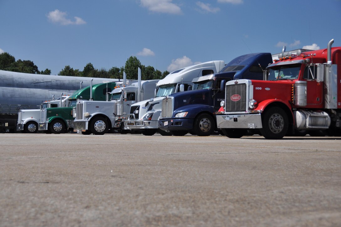 Semi-trucks line up on the flightline at Dobbins Air Reserve Base, Ga. Sept. 21, 2017 and wait to be offloaded. The trucks transported various supplies from all over the country to Dobbins where they were palletized and loaded onto C-17 Globemaster III aircraft and flown to provide hurricane relief. (U.S. Air Force photo/Tech. Sgt. Kelly Goonan)
