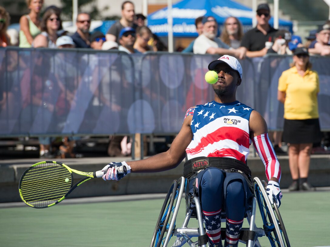 Roosevelt Anderson prepares to return a serve during a wheelchair tennis match.