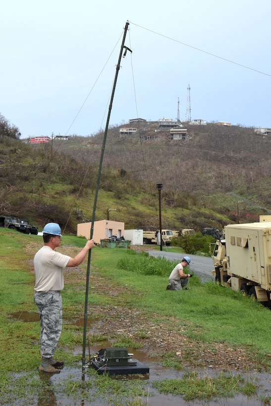 Master Sgt. David Fernelius, left, and Airman 1st Class David Zham finalize setting up an NVIS high frequency antenna.