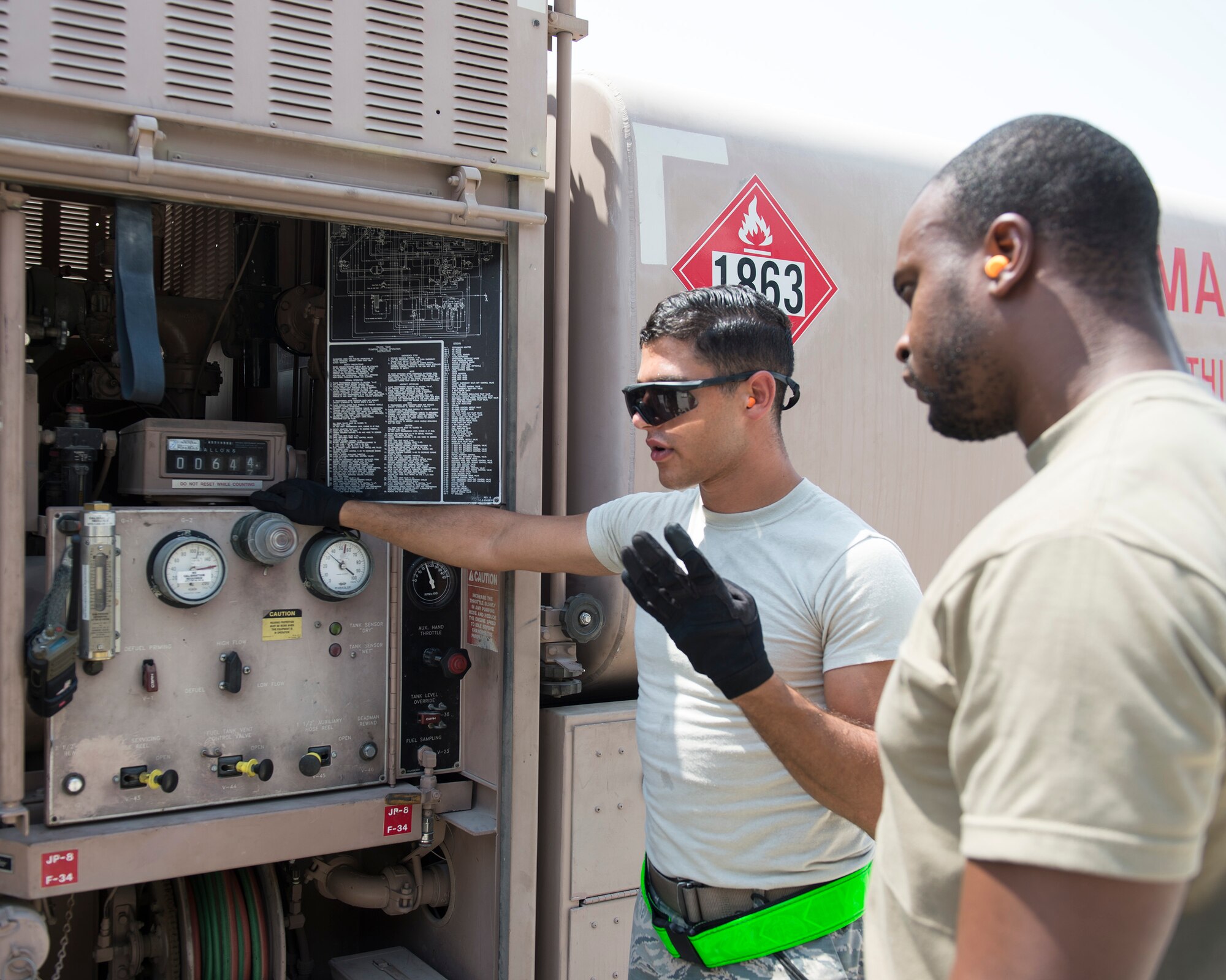U.S. Air Force Senior Airman Yahya Elgazar, left, fuels distribution technician with the 379th Expeditionary Logistics Readiness Squadron, Fuels Management Flight, talks about the importance of the gas meter to U.S. Army Spc. Anthony Jackson Jr., petroleum oils and lubricants specialist with the Headquarters and Headquarters Battalion 2-43 Air Defense Artillery, at Al Udeid Air Base, Qatar, Sept. 14, 2017.