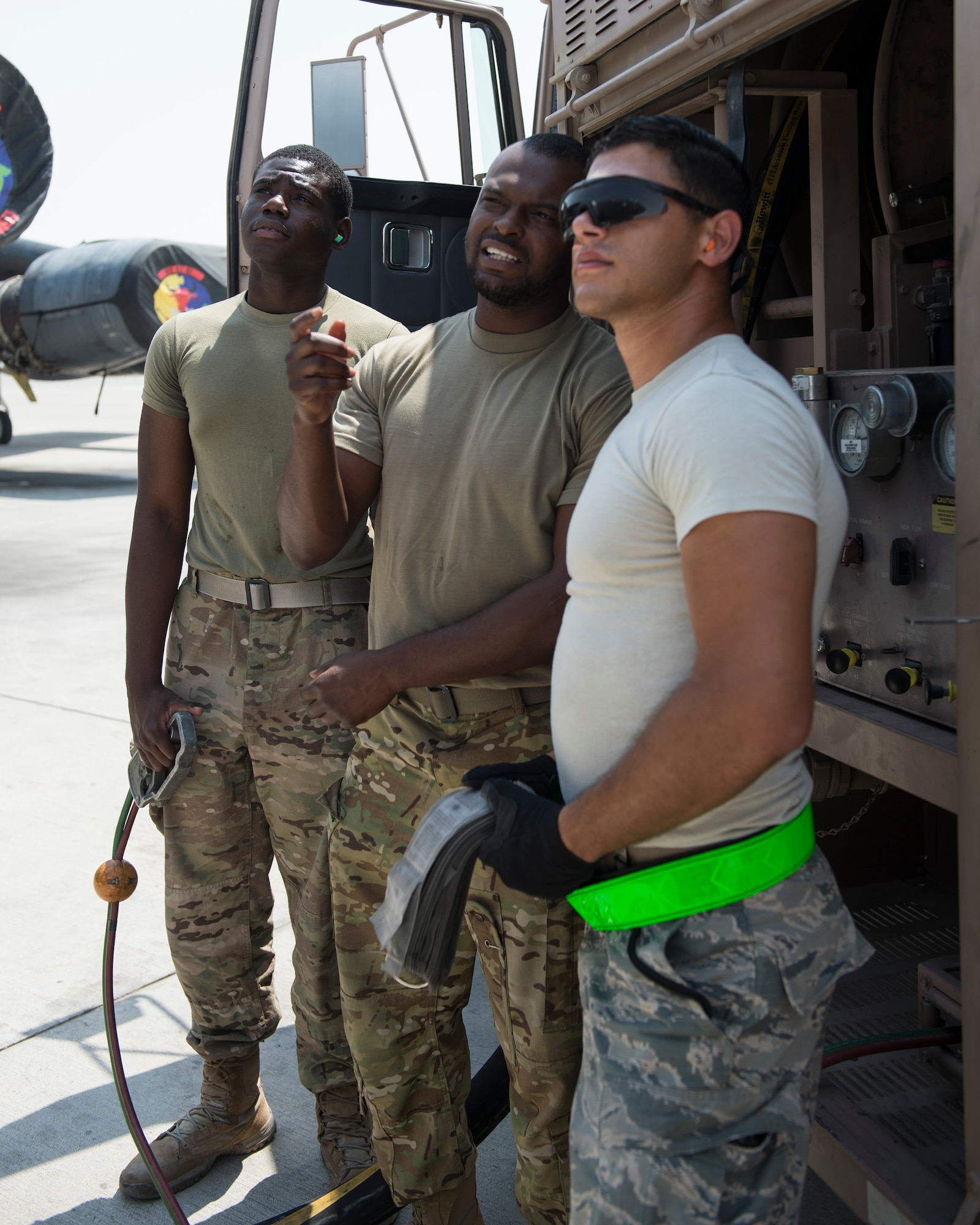 U.S. Army Pfc. Deonte Jenkins, left, signal support systems specialist and fuel handler with the Headquarters and Headquarters Battalion 2-43 Air Defense Artillery, holds the deadman switch during fueling operations at Al Udeid Air Base, Qatar, Sept. 14, 2017.