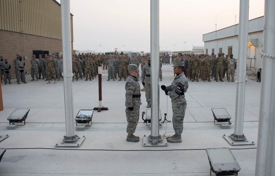 Service members, coalition partners and civilians gather together and take part in a 9/11 retreat ceremony at Al Udeid Air Base, Qatar, Sept. 11, 2017.