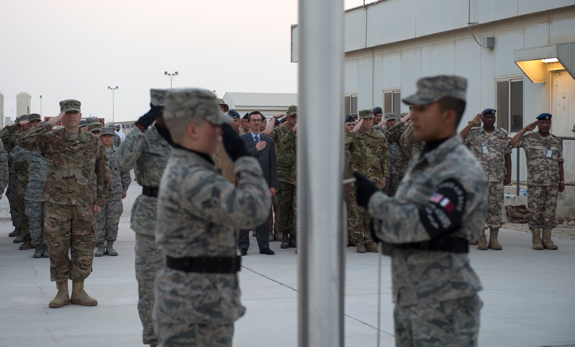 Service members, coalition partners and civilians gather together and take part in a 9/11 retreat ceremony at Al Udeid Air Base, Qatar, Sept. 11, 2017.