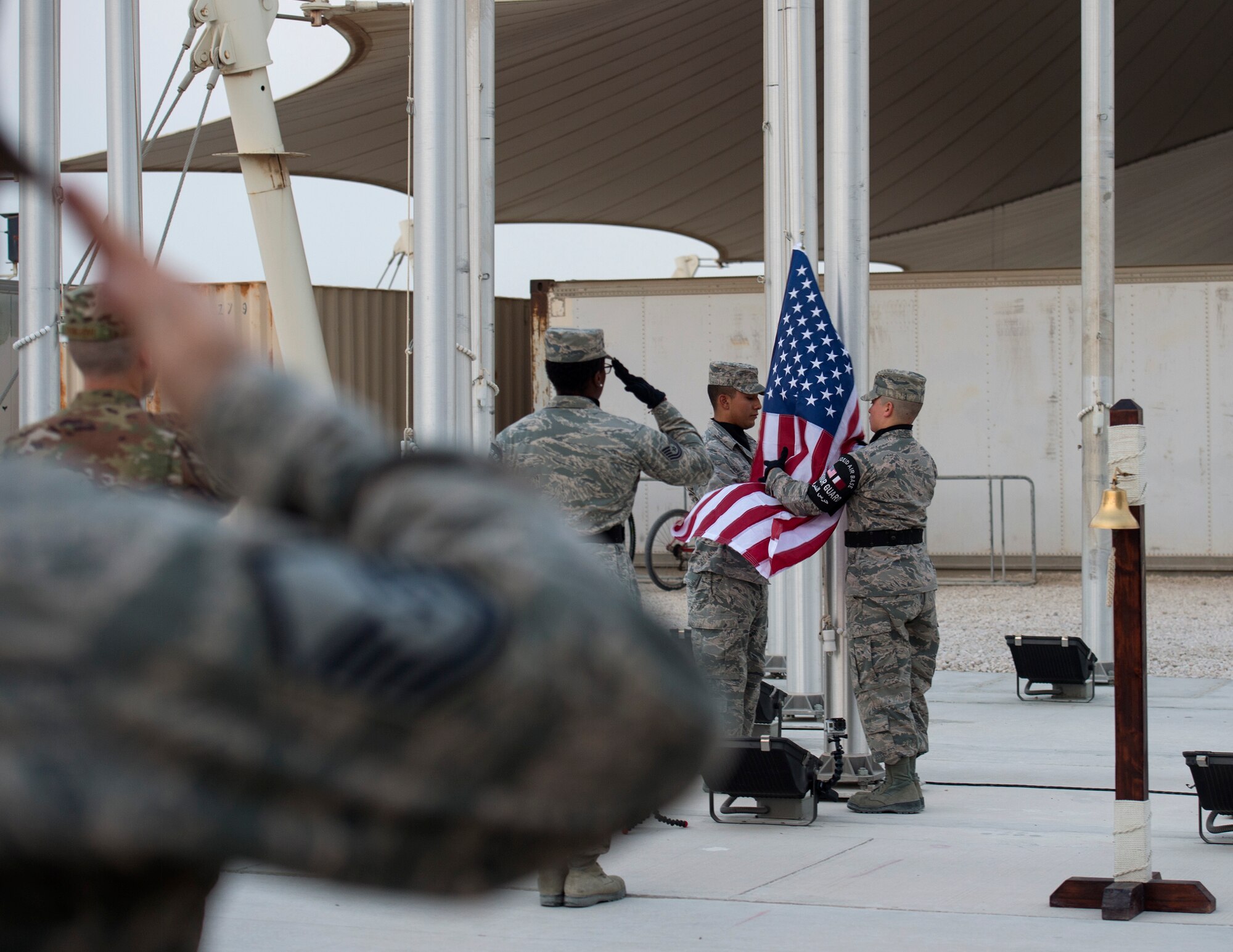 U.S. Air Force Airmen render a salute to the U.S. flag as it is being lowered during a 9/11 retreat ceremony at Al Udeid Air Base, Qatar, Sept. 11, 2017.