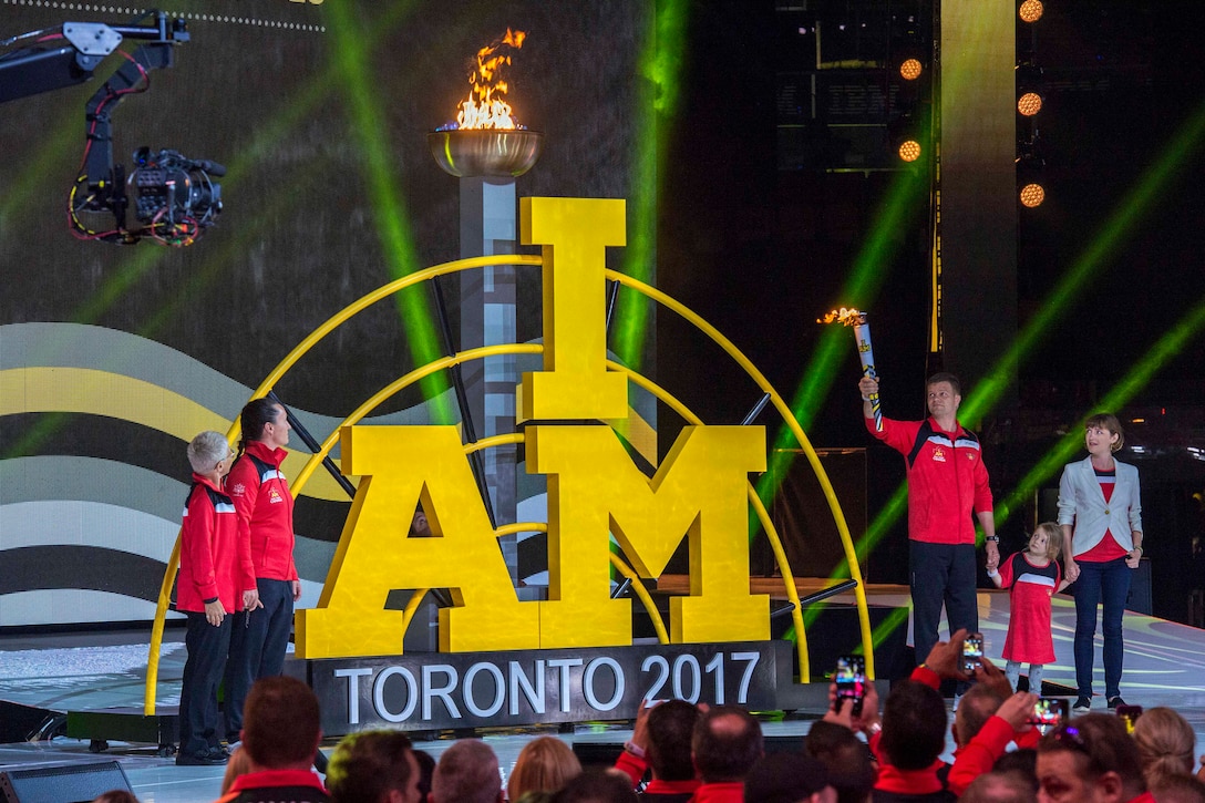 A man lights the 2017 Invictus Games torch.