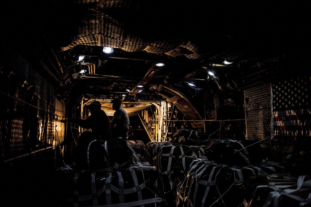 U.S. Army Staff Sgt. Jose Moreno (left), a parachute rigger assigned to the 294th Quartermaster Company, attaches static line rigging on an airdrop bundle in the rear of a C-130 aircraft at an undisclosed location in Southwest Asia, Sept. 10, 2017. Airdrop bundles are rigged within specific guidelines to ensure the cargo properly exits the aircraft, the parachute properly deploys and the bundle lands intact on its target. (U.S. Air Force photo by Tech. Sgt. Jonathan Hehnly)