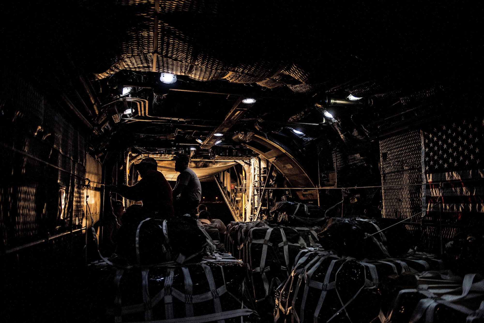U.S. Army Staff Sgt. Jose Moreno (left), a parachute rigger assigned to the 294th Quartermaster Company, attaches static line rigging on an airdrop bundle in the rear of a C-130 aircraft at an undisclosed location in Southwest Asia, Sept. 10, 2017. Airdrop bundles are rigged within specific guidelines to ensure the cargo properly exits the aircraft, the parachute properly deploys and the bundle lands intact on its target. (U.S. Air Force photo by Tech. Sgt. Jonathan Hehnly)