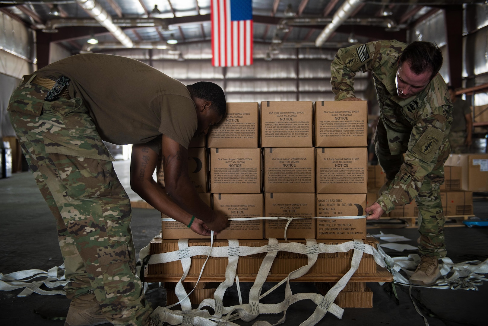 U.S. Army Sgt. Timothy Williams, a parachute rigger assigned to the 824th Quartermaster Company, and U.S. Army Staff Sgt. Justin Devaul, a parachute rigger assigned to an Army special operations forces unit, work together to build an airdrop bundle of meals, ready-to-eat for forward deployed troops at an undisclosed location in Southwest Asia, Sept. 6, 2017. Airdrop bundles are rigged within specific guidelines to ensure the cargo properly exits the aircraft, the parachute properly deploys and the bundle lands intact on its target. (U.S. Air Force photo by Tech. Sgt. Jonathan Hehnly)
