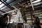 A team of U.S. Army parachute riggers rig a supply bundle in preparation for an airdrop mission at an undisclosed location in Southwest Asia, Sept. 6, 2017. Airdrop bundles are rigged within specific guidelines to ensure the cargo properly exits the aircraft, the parachute properly deploys and the bundle lands intact on its target. (U.S. Air Force photo by Tech. Sgt. Jonathan Hehnly)