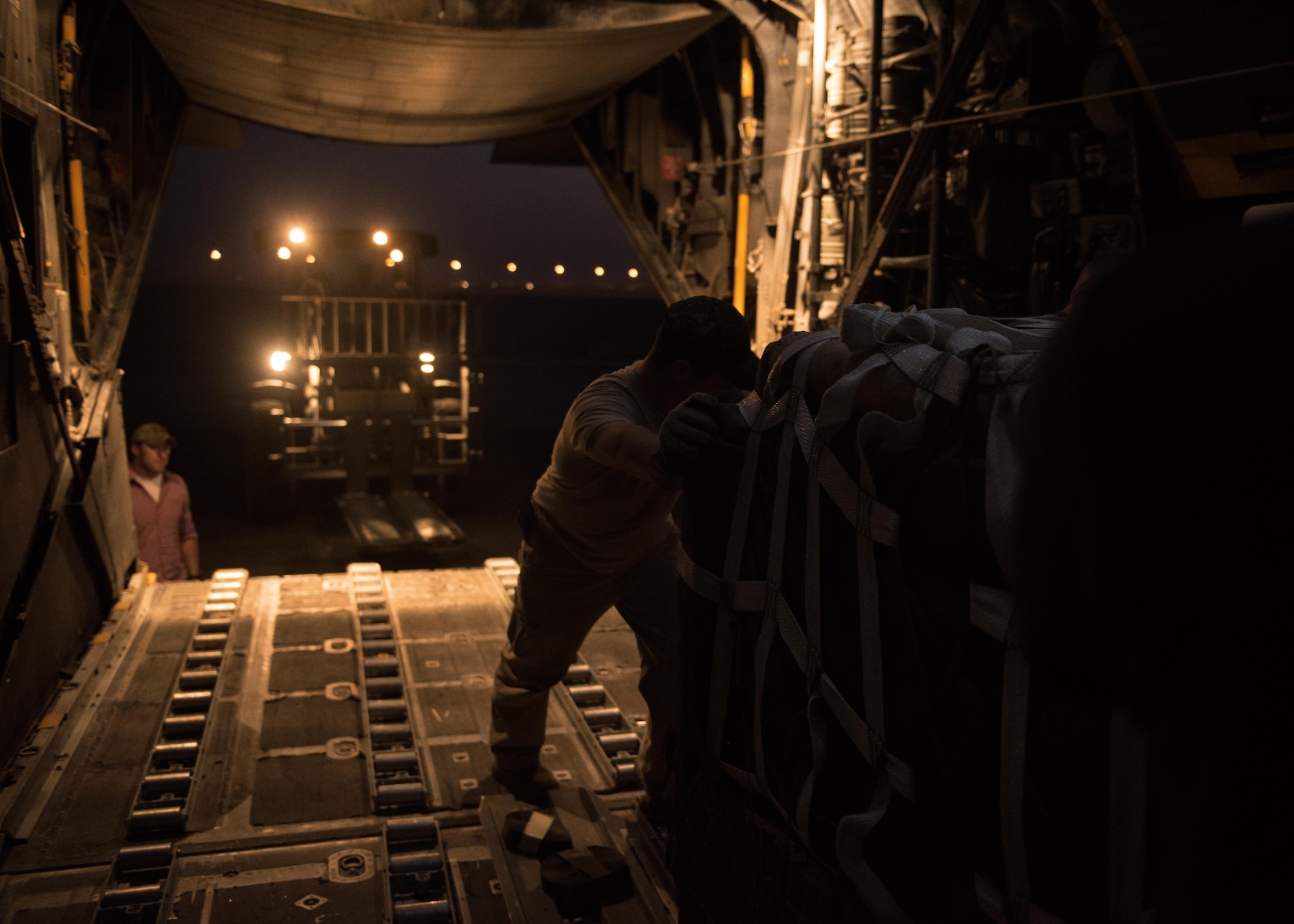 An U.S. Air Force loadmaster loads a C-130 aircraft with supply bundles in preparation for an airdrop mission at an undisclosed location in Southwest Asia, Sept. 10, 2017. Airdrop bundles are rigged within specific guidelines to ensure the cargo properly exits the aircraft, the parachute properly deploys and the bundle lands intact on its target. (U.S. Air Force photo by Tech. Sgt. Jonathan Hehnly)