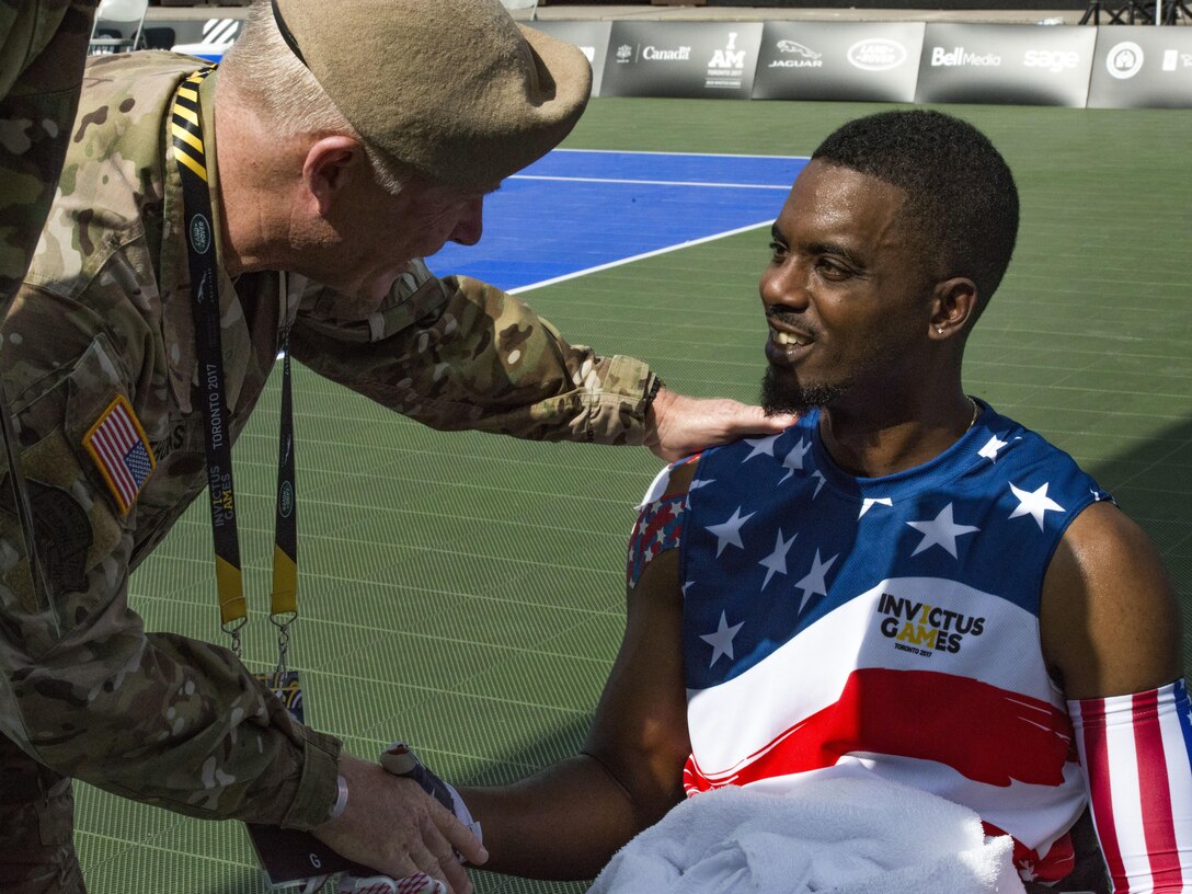 Army Gen. Raymond A. Thomas III, commander of U.S. Special Operations Command, shakes hands with Roosevelt Anderson, a medically retired Army Special Forces sergeant, after a tennis match at the Invictus Games in Toronto, Sept. 23, 2017.