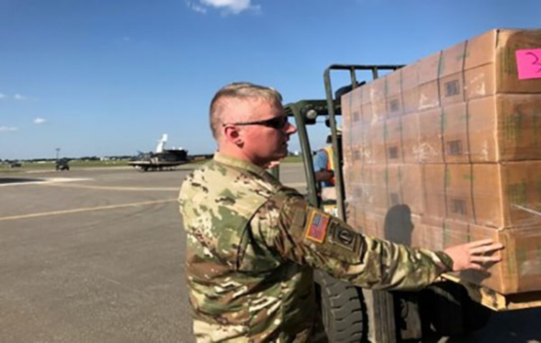 DLA Distribution Expeditionary commander U.S. Army Maj. Jesse B. Holmes inspects a pallet of supplies before it is loaded onto Texas National Guard and U.S. Border Patrol CH-47, UH-60, and UH-1 aircraft at Randolph Auxiliary Airfield in Seguin, Texas.