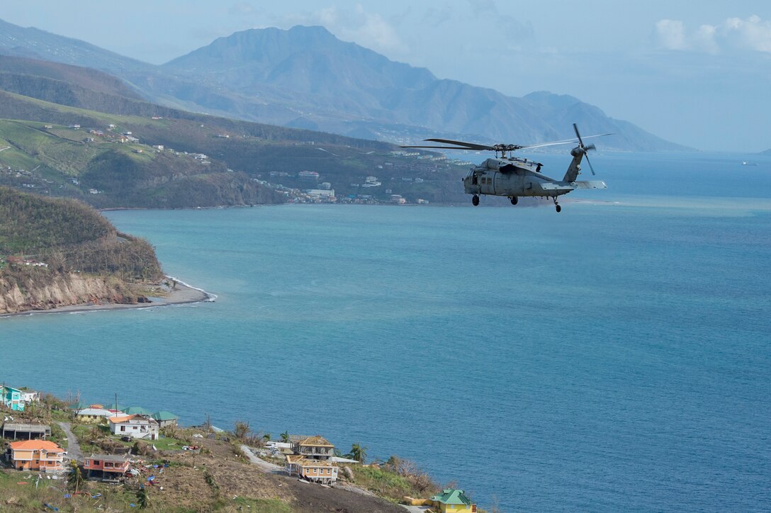 MH-60S helicopters from Helicopter Sea Combat 22 (HSC-22) attached to the amphibious assault ship USS Wasp (LHD 1) survey damage over the island of Dominica
