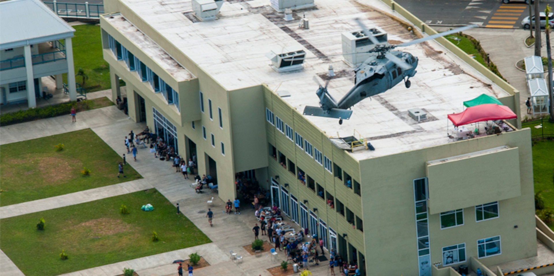 A U.S. Navy MH-60S Sea Hawk prepares to land to evacuate victims from the island of Dominica following the landfall of Hurricane Maria.