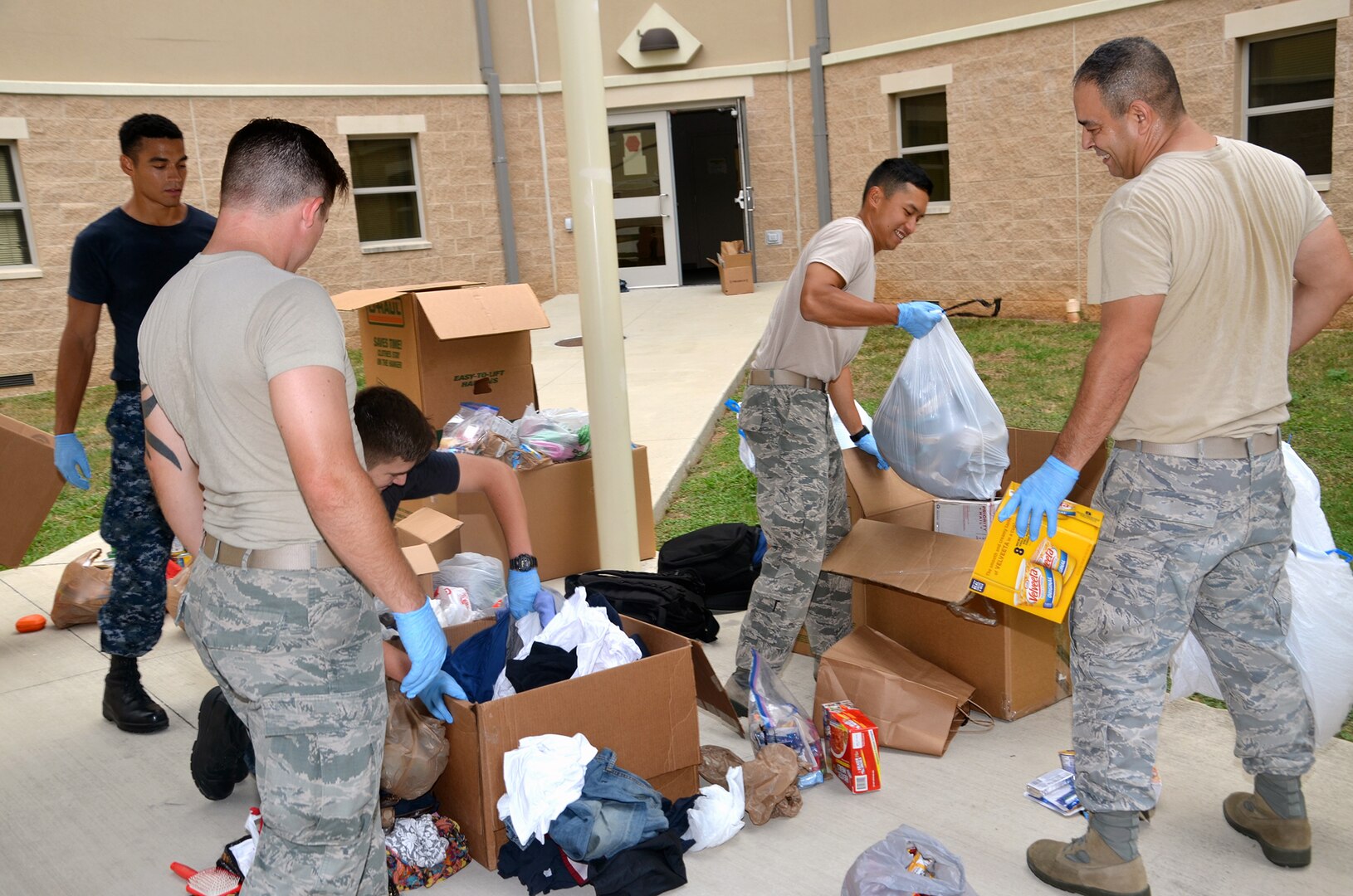 Air Force,  Navy and civilian volunteers from the Medical Education and Training Campus (METC), 59th Training Group, and Navy Medicine Training Support Center (NMTSC) unload donations collected for victims of Hurricane Harvey to the sorting area Sept. 19. In all, the team collected and donated 450 pounds of food to the San Antonio Food Bank, $3,300 in donated diapers to the Diaper Bank, $19,000 in clothing and incidentals to the Salvation Army, and numerous donations to the American Society for the Prevention of Cruelty to Animals and homeless shelters.