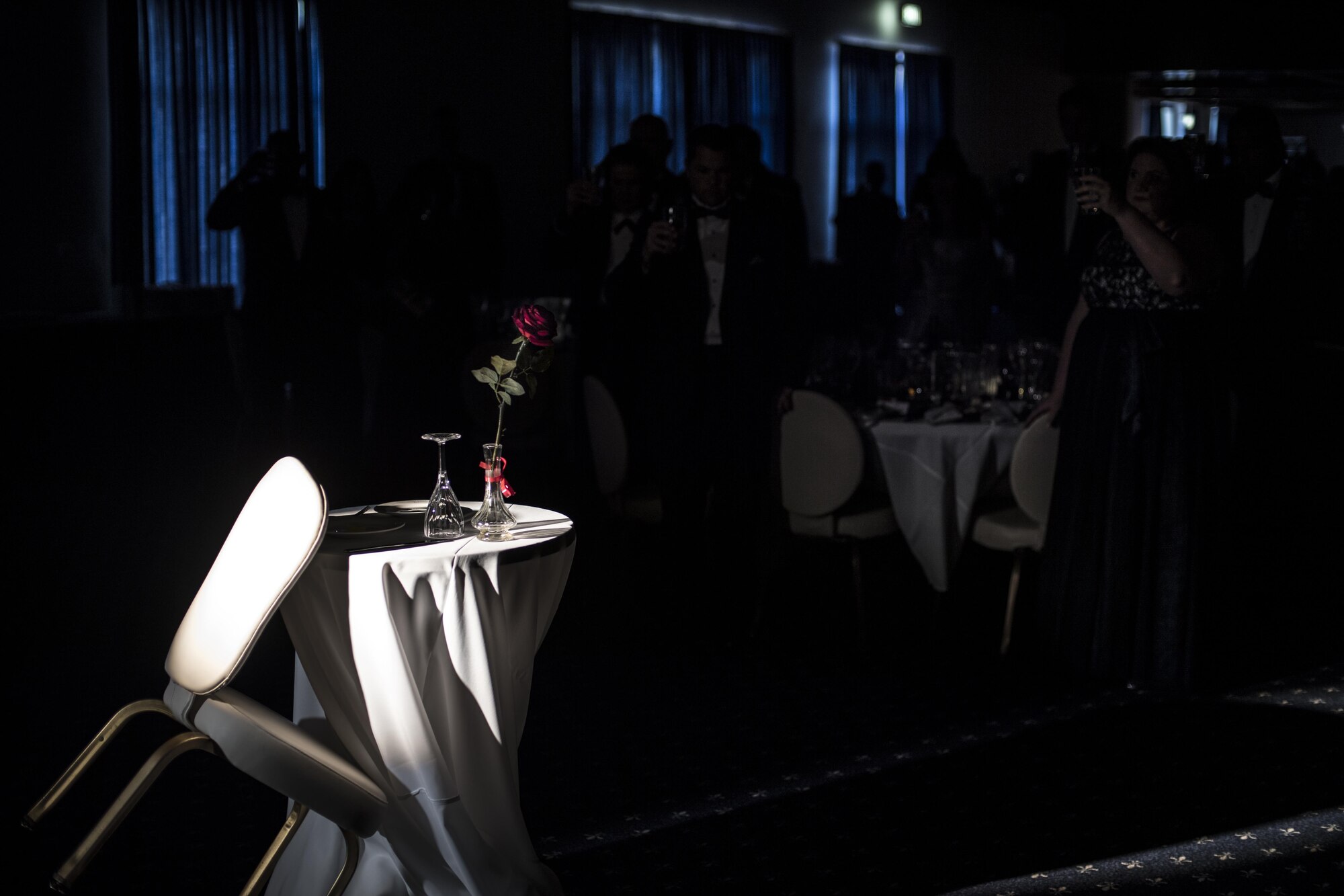 U.S. Air Force Airmen and their families hold their glasses up to the Missing Man Table during the Air Force Ball at the officer’s club on Ramstein Air Base, Germany, Sept. 23, 2017.
